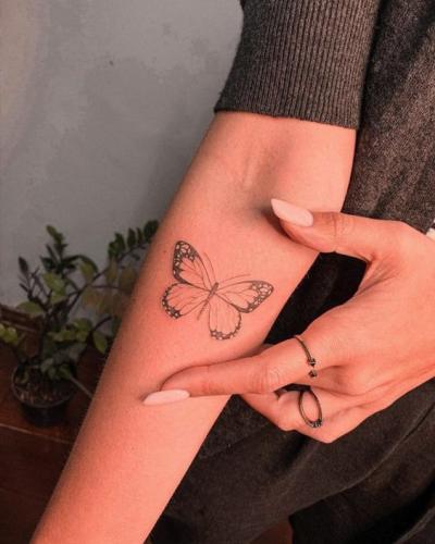 Joli tatouage papillon sobre sur l'avant-bras